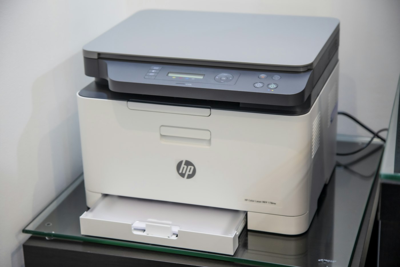 Modern laser printer printing color documents in office